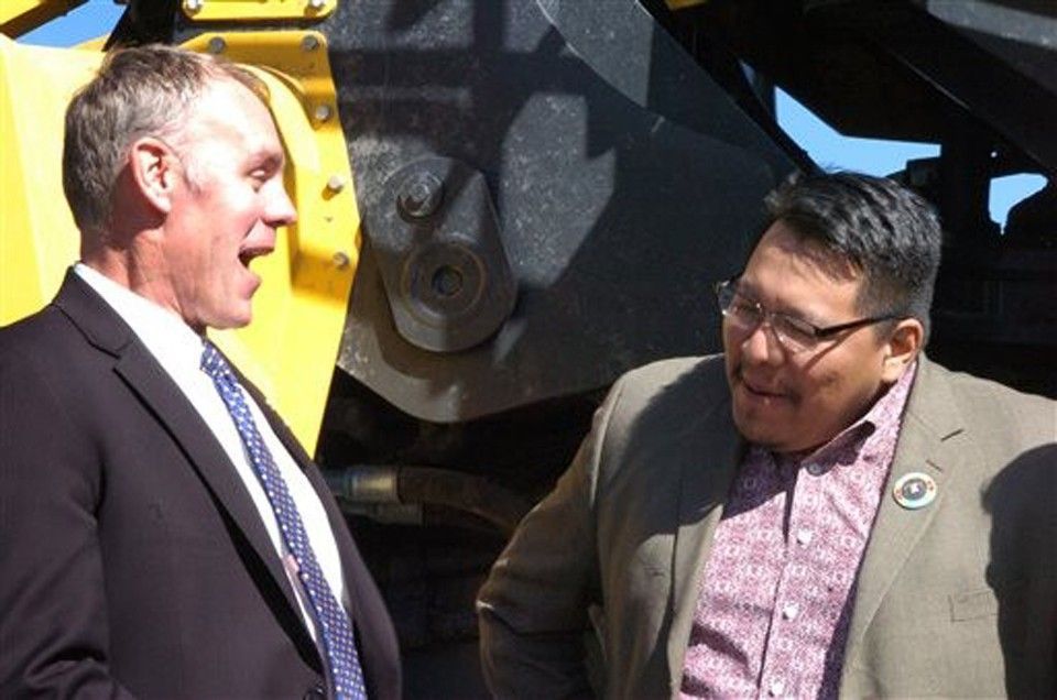 U.S. Rep. Ryan Zinke, left, laughs with Darrin Old Coyote